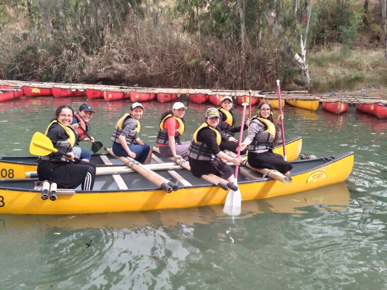 Group of people canoeing on calm water