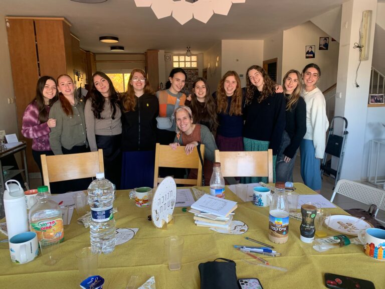 Smiling group of women gathered around table