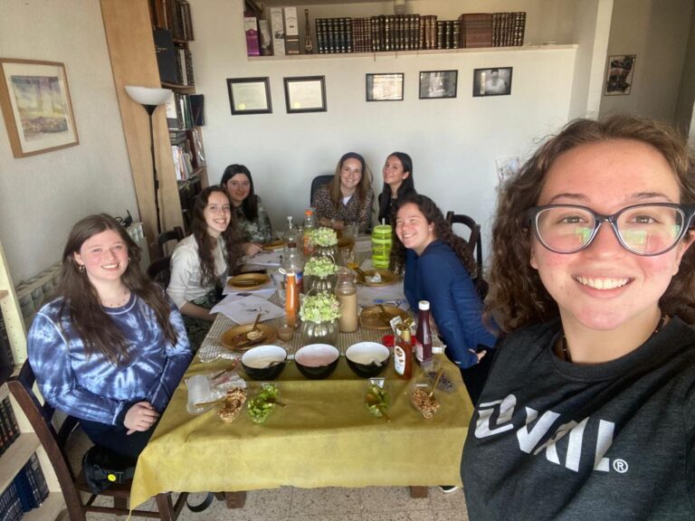 Group of friends taking selfie at dining table
