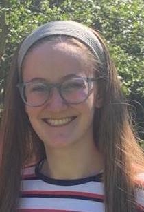 Smiling young woman with glasses outdoors