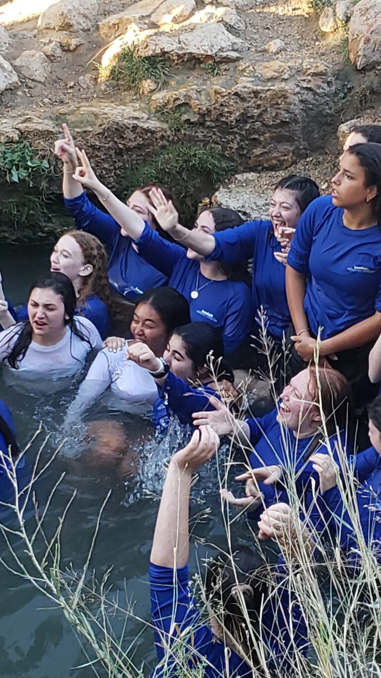 Group of girls in blue shirts in water
