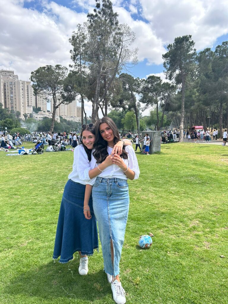 Two friends hugging in a city park