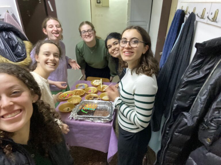 Group of women smiling around food table