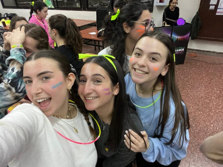 Smiling girls with neon face paint at party