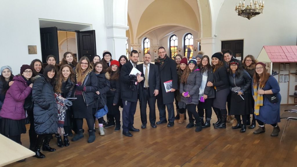 Large group posing in arched church hall
