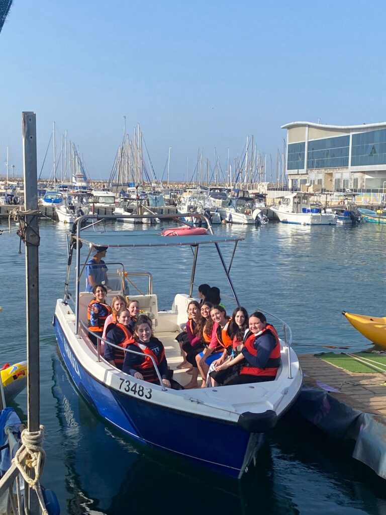 People wearing life jackets on marina boat
