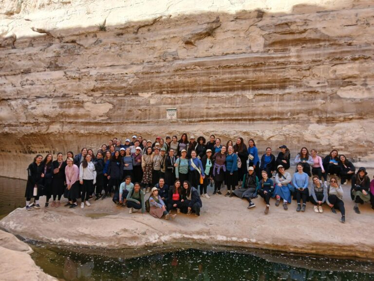Large group posing at canyon oasis pool