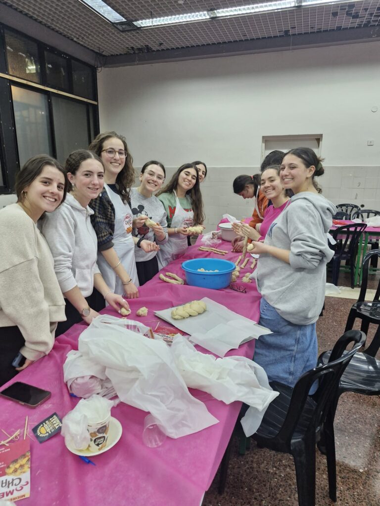 Smiling group making homemade bread at table