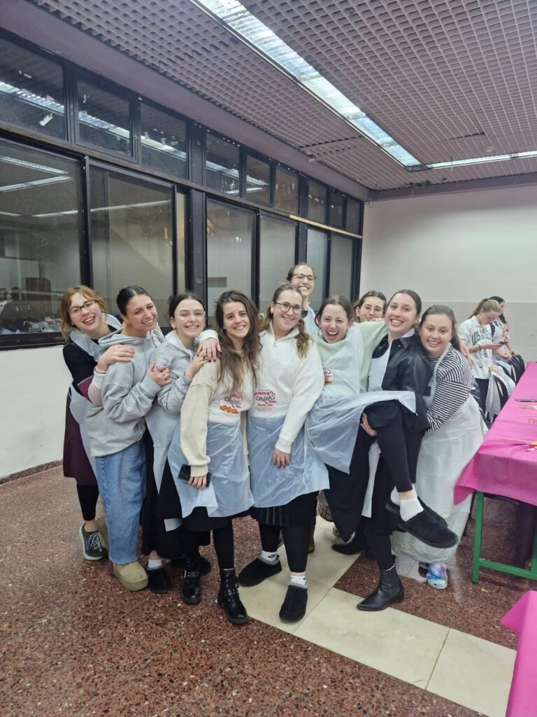 Smiling group of young women wearing aprons