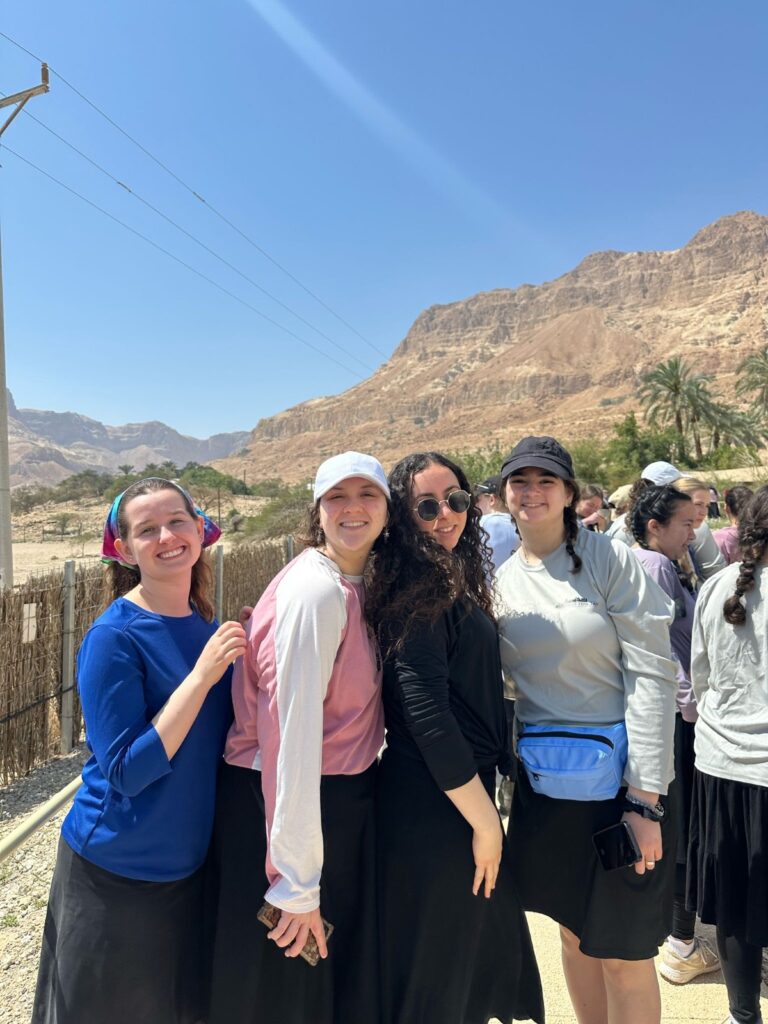 Smiling women posing in desert mountain landscape