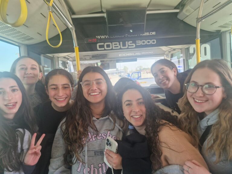 Smiling young women posing on airport shuttle