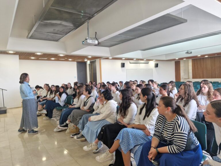 Audience listening to speaker in lecture room
