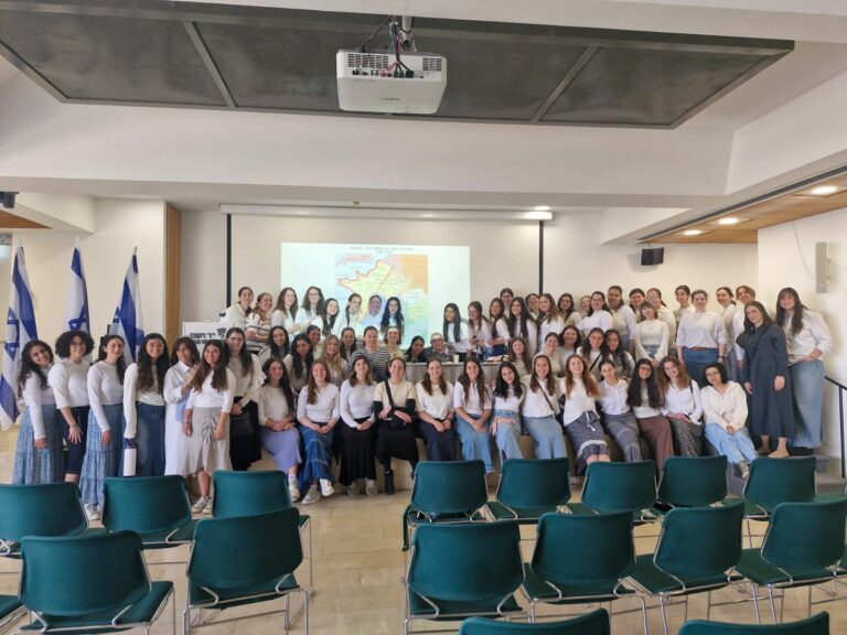 Large group of women posing in lecture hall