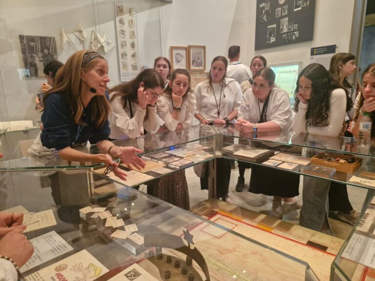 Museum guide explaining artifacts to students