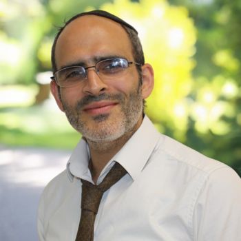 Smiling bearded man wearing glasses and kippah