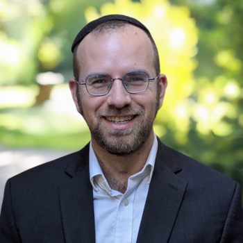 Smiling man wearing glasses and a suit