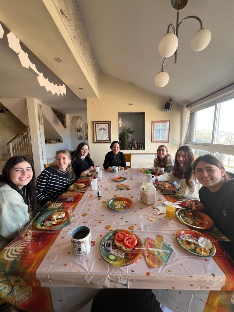 Group of people gathered around table eating