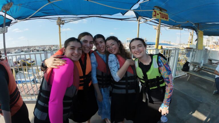 Five friends in life vests at marina