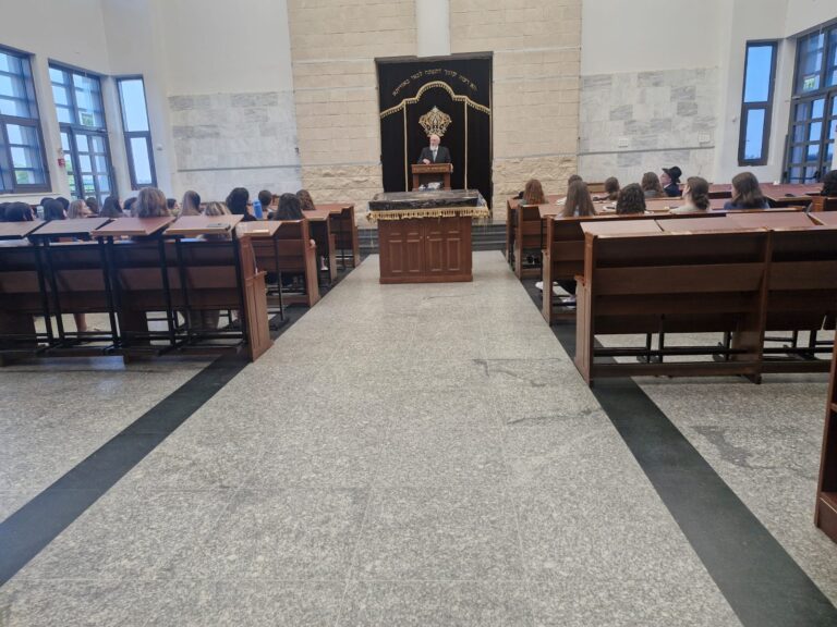 Congregation in synagogue facing ark and speaker