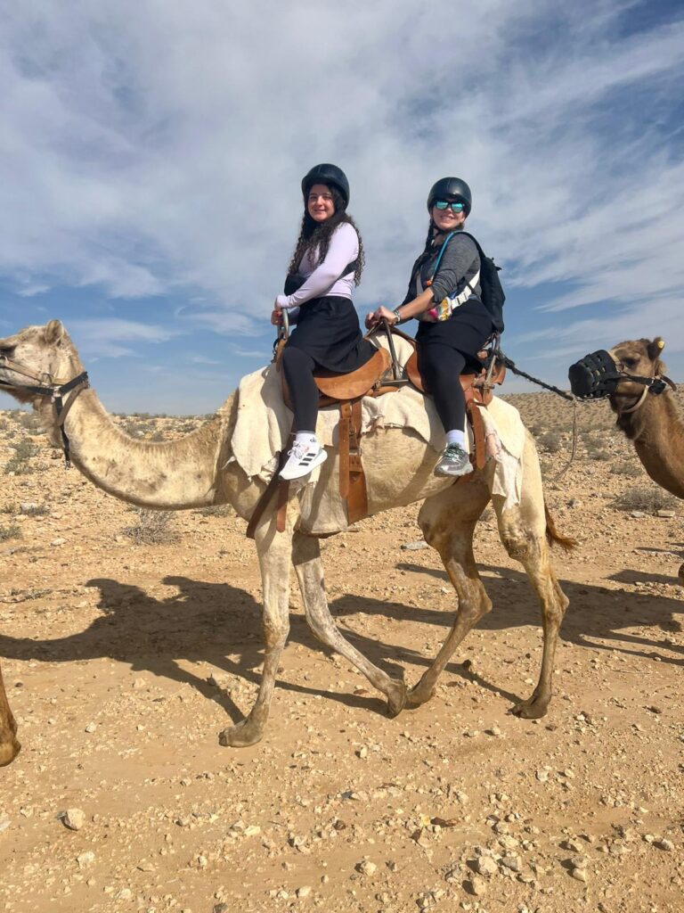 Two riders on camels in desert