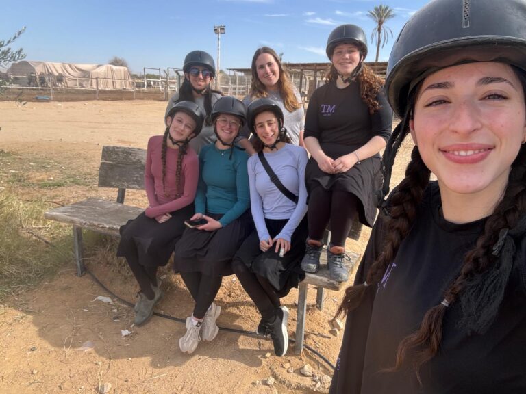 Group of young women smiling in riding helmets