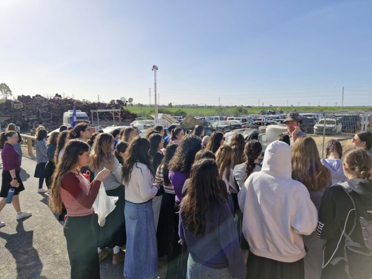 Students touring a scrapyard outdoors