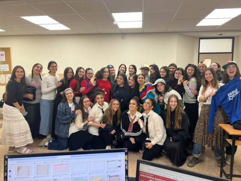 Large group of smiling students in classroom