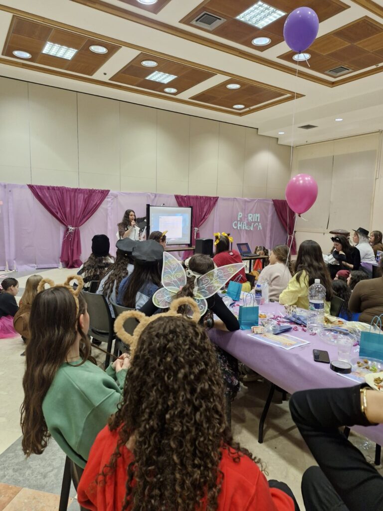Children at purple party listening to presenter