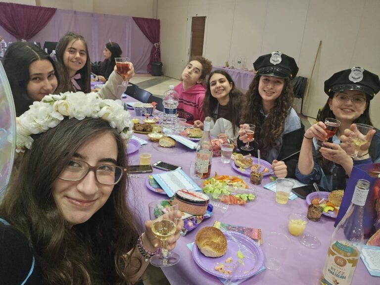 Friends raising glasses at purple-themed party