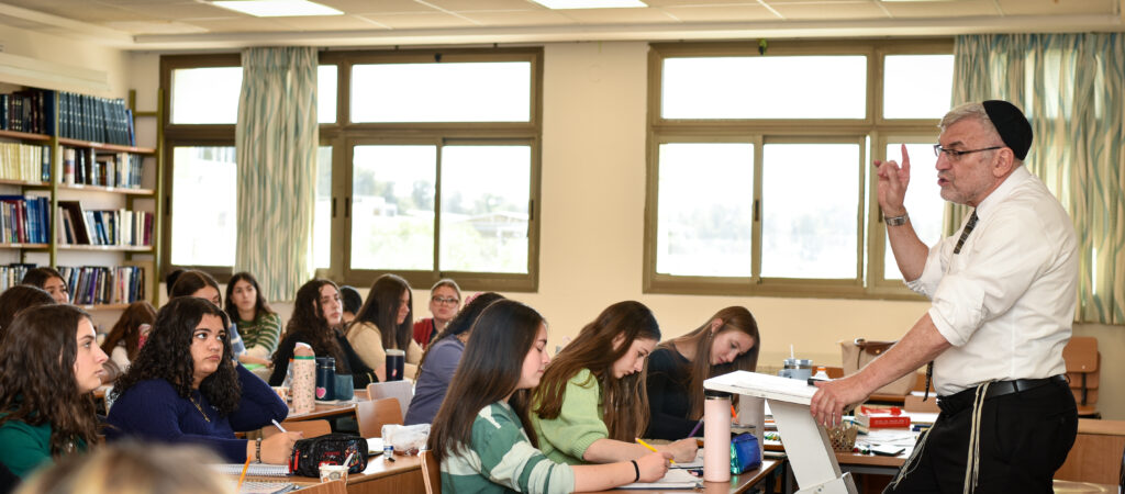 Teacher lecturing students in classroom